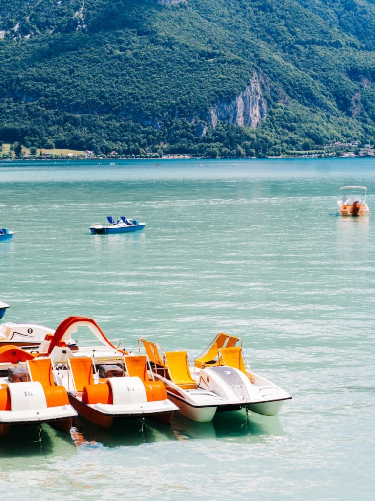 white and orange boat on sea during daytime